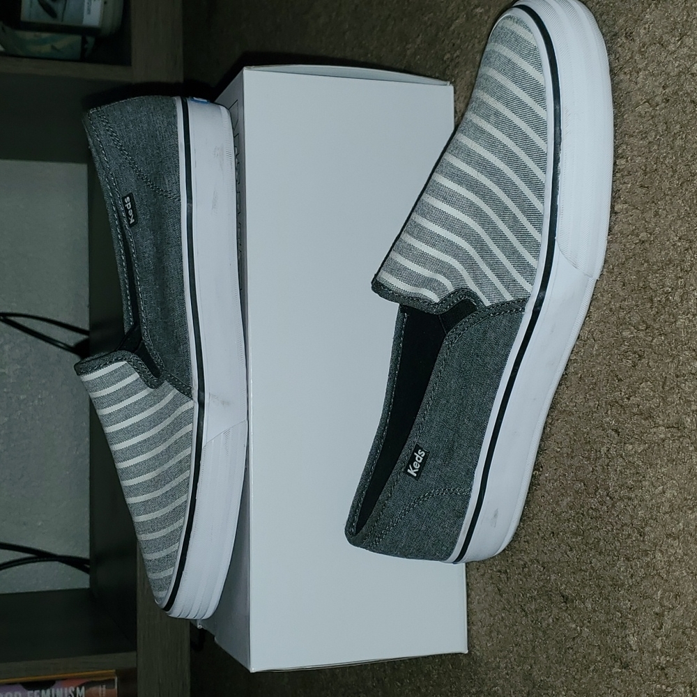 Grey, White, and Denim Keds Women size 11 slip-on sneakers.